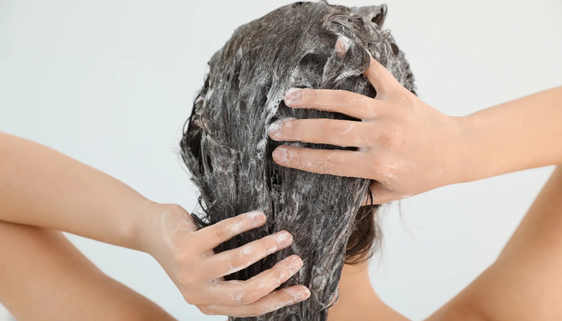 Person applying anti-dandruff shampoo 